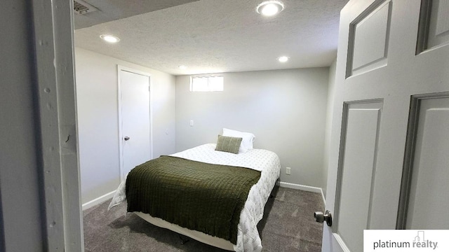 bedroom with recessed lighting, a textured ceiling, and carpet flooring