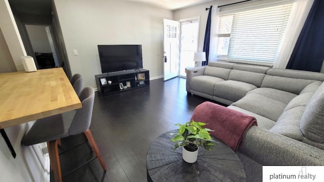 living room featuring dark wood finished floors and baseboards