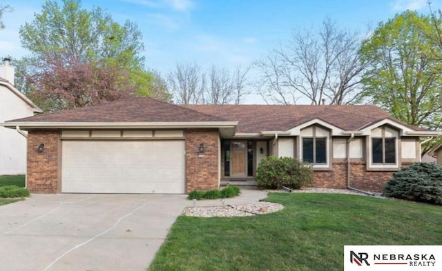 view of front facade featuring a garage, brick siding, and concrete driveway