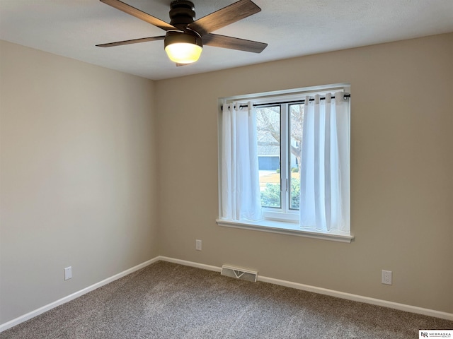 spare room featuring visible vents, baseboards, carpet, and ceiling fan