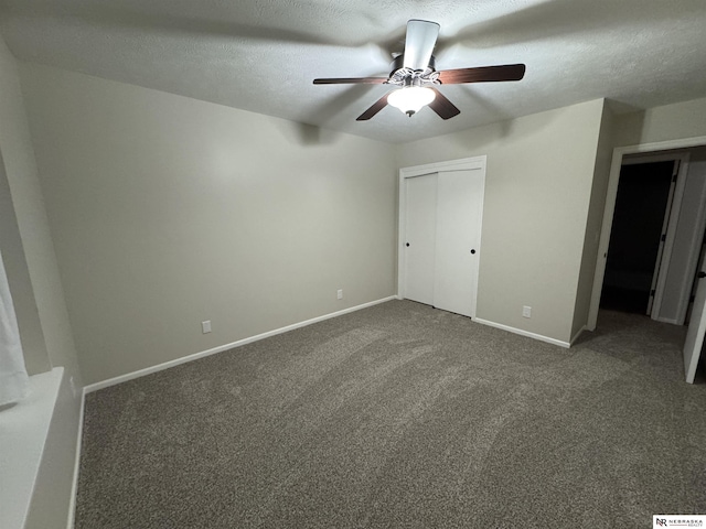 unfurnished bedroom featuring carpet, baseboards, a closet, and a textured ceiling