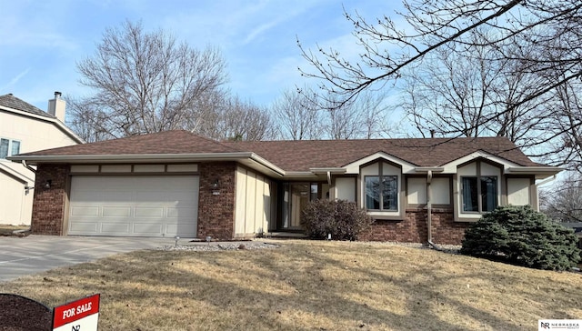 ranch-style house with brick siding, a shingled roof, a front yard, driveway, and an attached garage