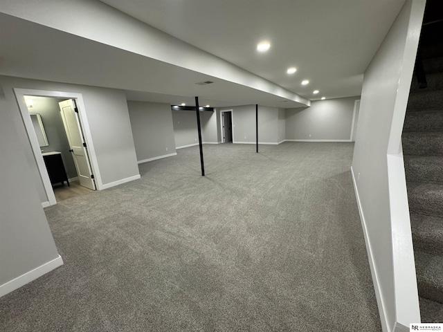 finished below grade area featuring recessed lighting, stairs, baseboards, and carpet floors