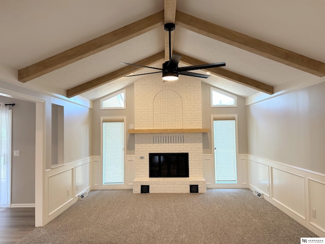 unfurnished living room with a wealth of natural light, ceiling fan, and a decorative wall