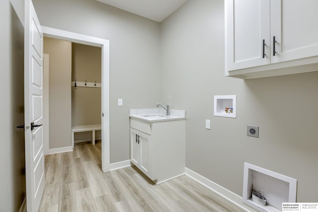 clothes washing area featuring electric dryer hookup, light wood-type flooring, a sink, cabinet space, and hookup for a washing machine