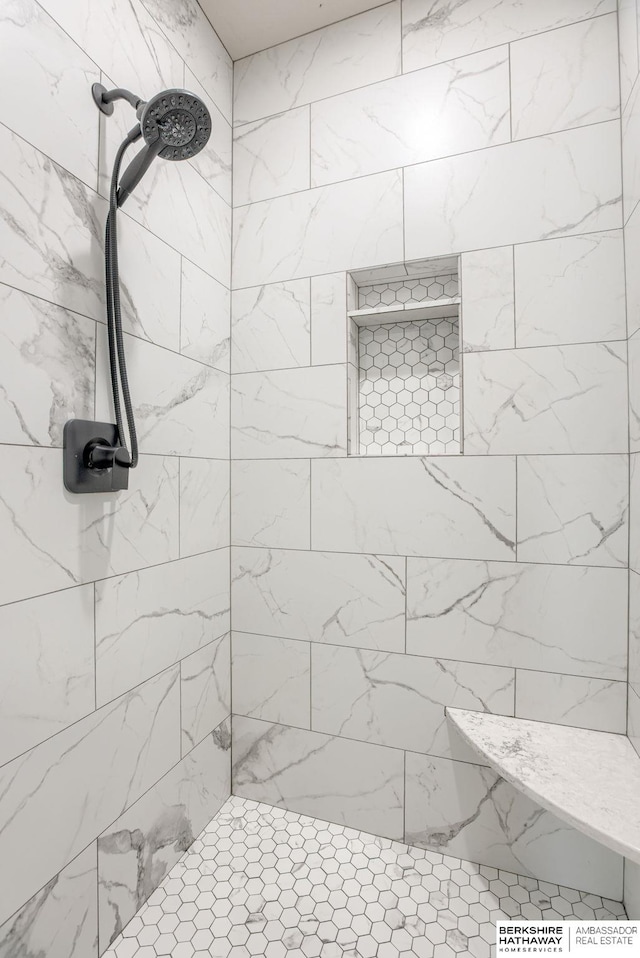 bathroom with a tile shower