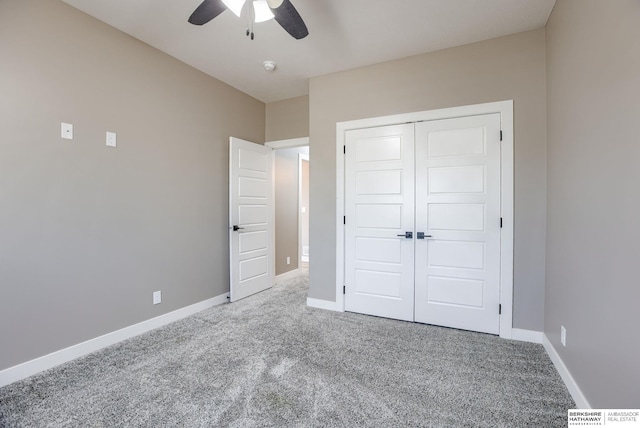 unfurnished bedroom with carpet, baseboards, a closet, and ceiling fan