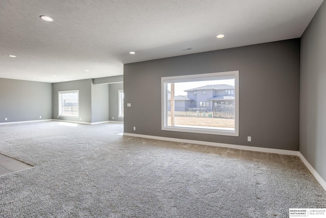 empty room with visible vents, baseboards, recessed lighting, a textured ceiling, and carpet flooring