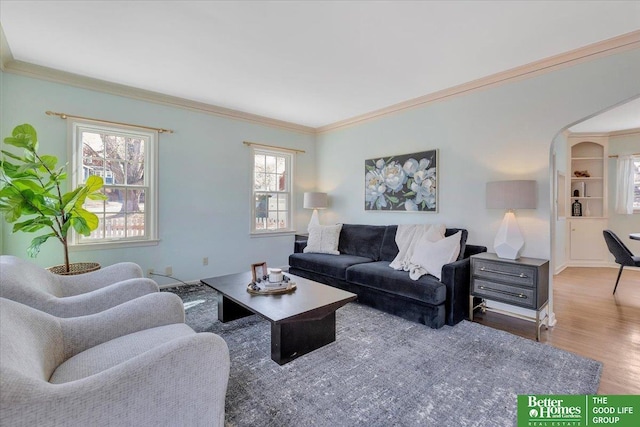 living area featuring crown molding and wood finished floors