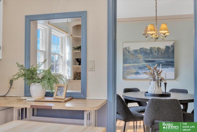 dining room featuring wallpapered walls and a notable chandelier