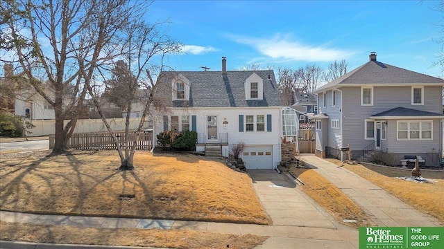 view of front of property with fence, a garage, driveway, and roof with shingles