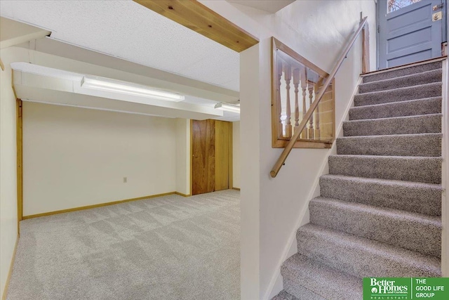 stairs with baseboards and carpet floors