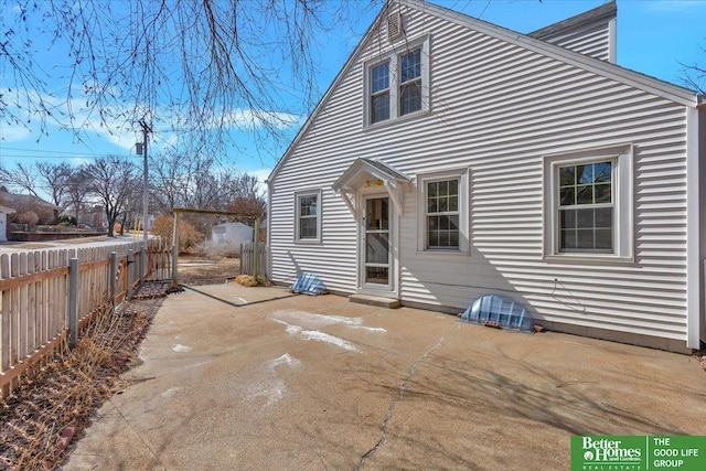 rear view of property with a patio area and fence