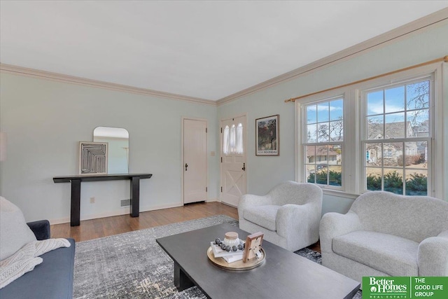 living room with baseboards, wood finished floors, and crown molding