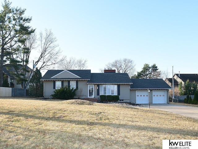 ranch-style home with fence, concrete driveway, a front yard, a chimney, and a garage