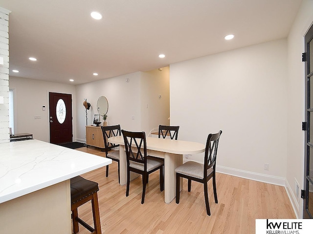 dining room featuring recessed lighting, light wood-type flooring, and baseboards