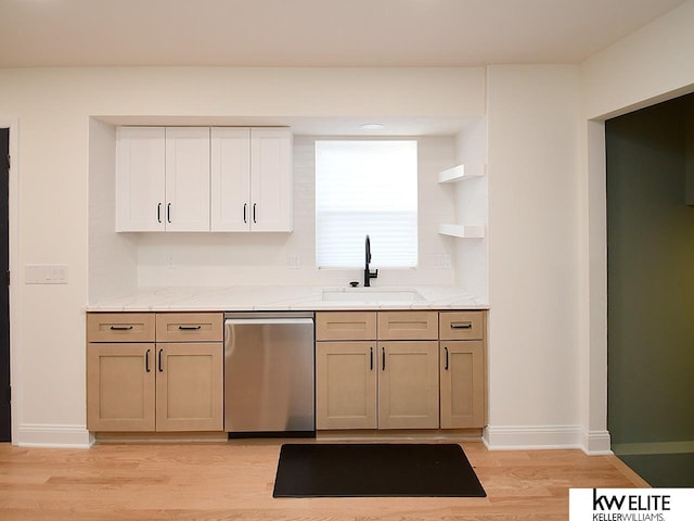 kitchen with dishwasher, light wood-style flooring, baseboards, and a sink