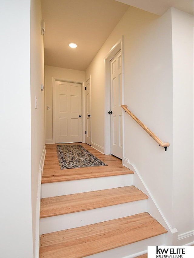 stairs featuring recessed lighting, baseboards, and wood finished floors