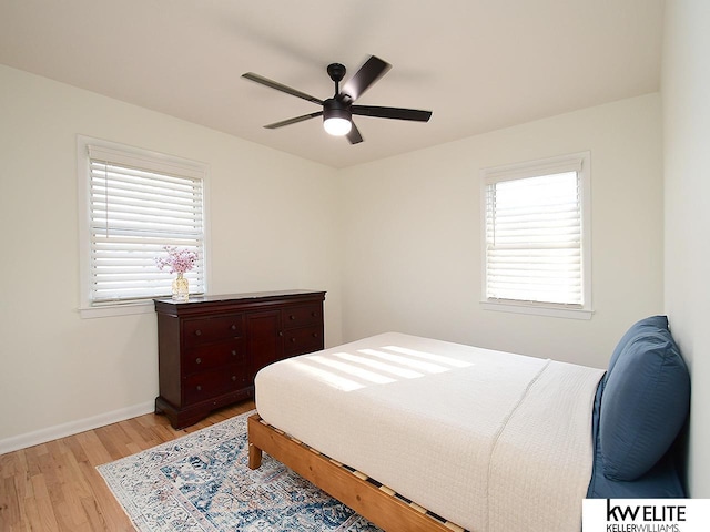 bedroom featuring light wood-type flooring, baseboards, and ceiling fan