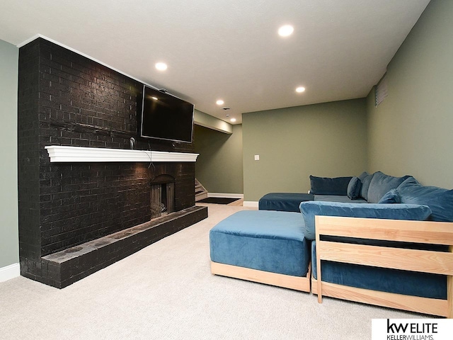 living room with carpet flooring, recessed lighting, a brick fireplace, and baseboards