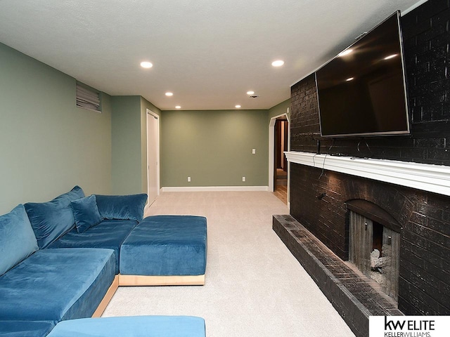 living area with recessed lighting, baseboards, light colored carpet, and a brick fireplace