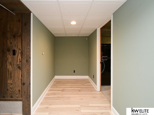 hallway with baseboards and light wood-style flooring