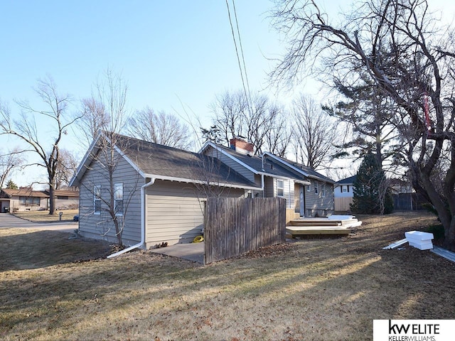 view of side of home featuring a lawn