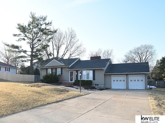 ranch-style house with driveway, a chimney, an attached garage, and fence