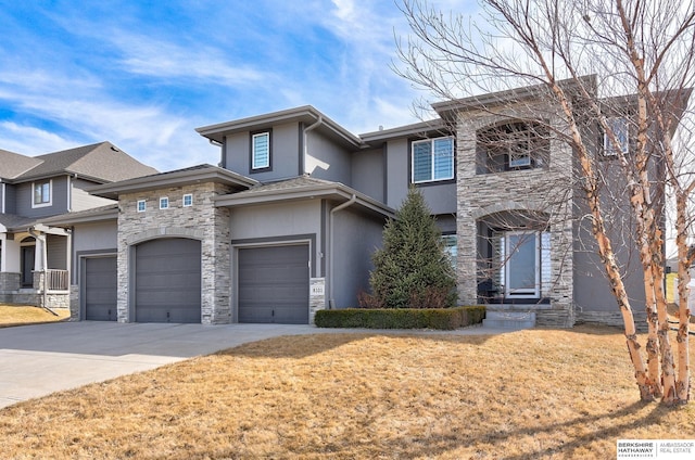 view of front of home featuring concrete driveway, a front lawn, stone siding, and stucco siding