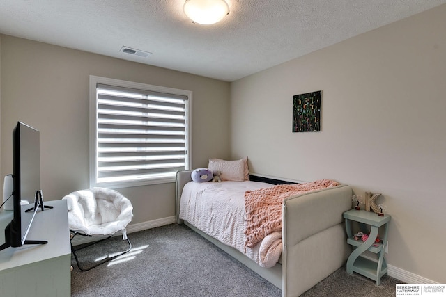 carpeted bedroom featuring visible vents, a textured ceiling, and baseboards