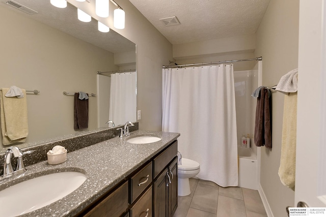 bathroom with tile patterned flooring, visible vents, and a sink