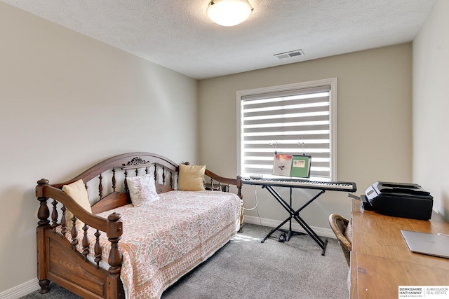 bedroom with baseboards, visible vents, a textured ceiling, and carpet