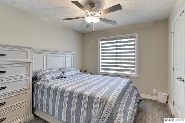 bedroom with baseboards, a textured ceiling, ceiling fan, and dark carpet