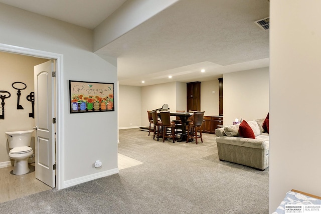 living room featuring visible vents, recessed lighting, baseboards, and carpet floors