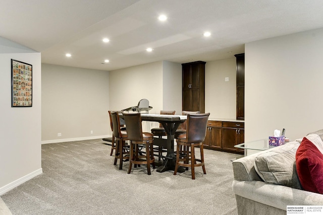 dining room featuring recessed lighting, light colored carpet, and baseboards