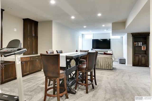 dining area with recessed lighting, baseboards, and light carpet