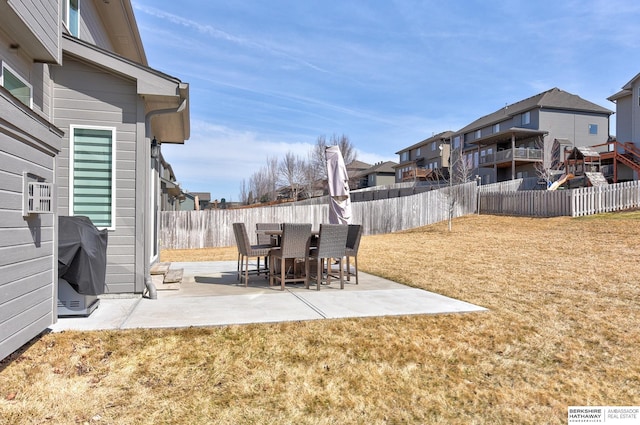 view of yard featuring a residential view, a fenced backyard, and a patio area