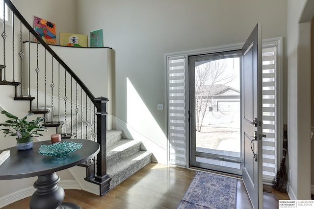 foyer entrance featuring stairs and wood finished floors