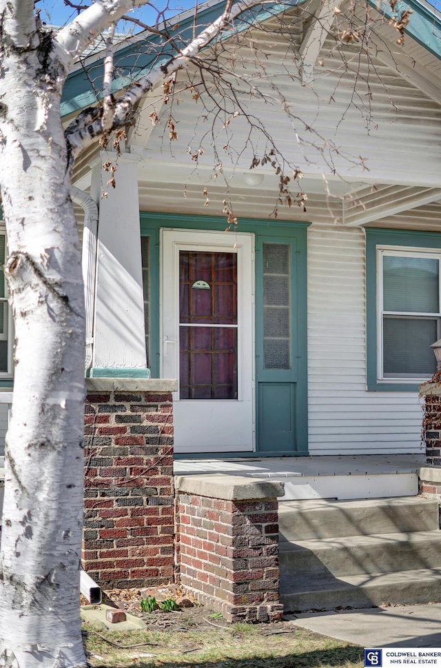 view of exterior entry with a porch