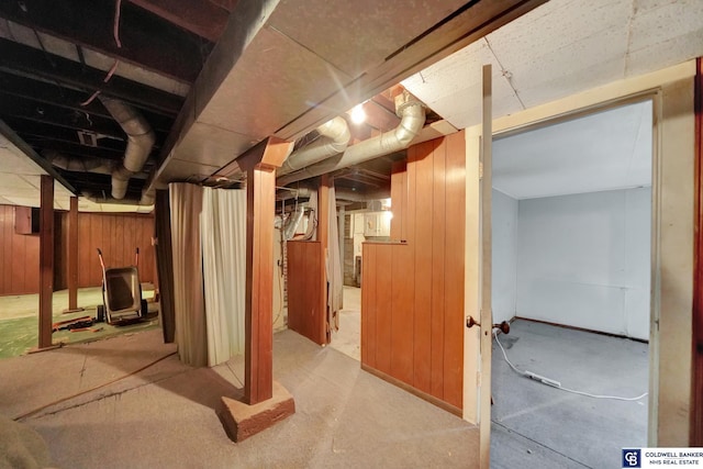 unfinished basement featuring wood walls