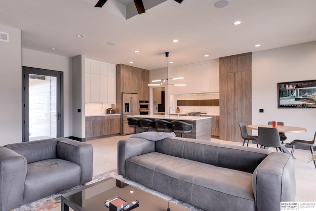 living room featuring visible vents and recessed lighting