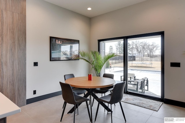 dining space featuring light tile patterned flooring, recessed lighting, and baseboards