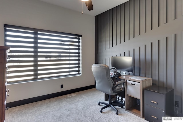 carpeted office space with visible vents and baseboards