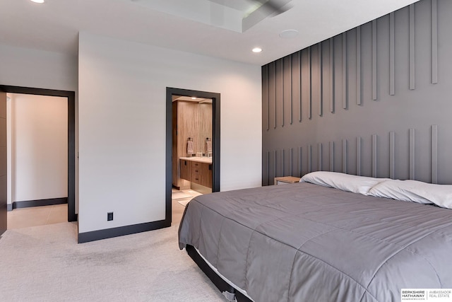 bedroom featuring connected bathroom, recessed lighting, baseboards, and light carpet