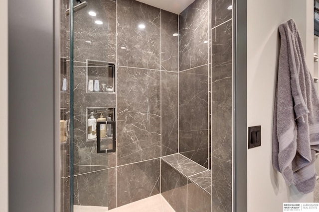 bathroom with tiled shower