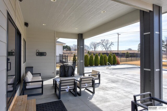 view of patio / terrace with area for grilling and fence