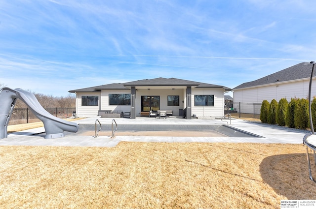 rear view of property with a patio area and fence