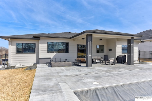 rear view of property with a patio area, fence, and an outdoor hangout area