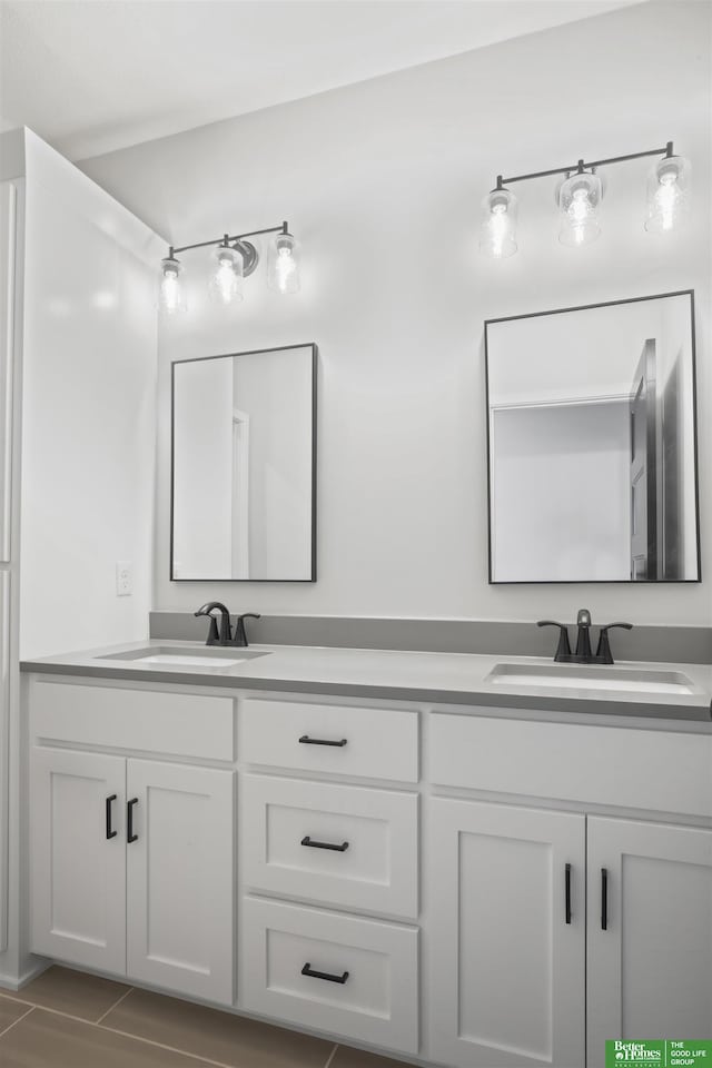 bathroom with a sink and double vanity