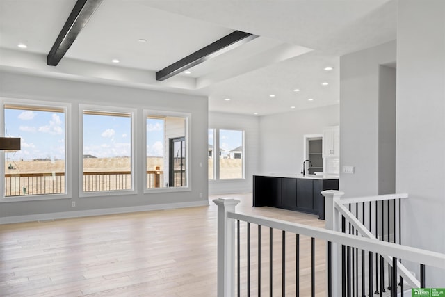 living room featuring beamed ceiling, recessed lighting, light wood-type flooring, and baseboards